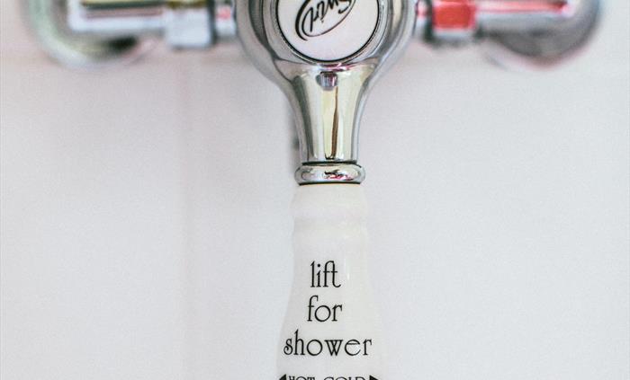 Victorian style hot and cold shower tap.